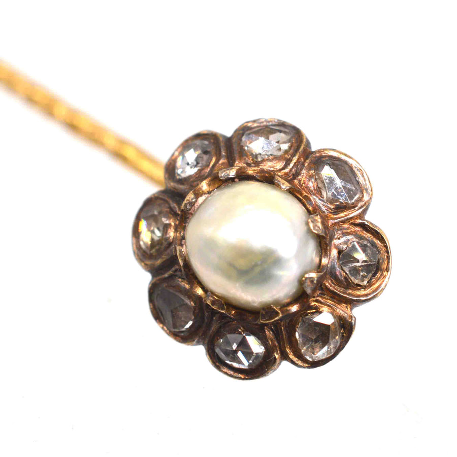 19th Century tie pin featuring a natural pearl center surrounded by rose cut diamonds elegantly arranged.
