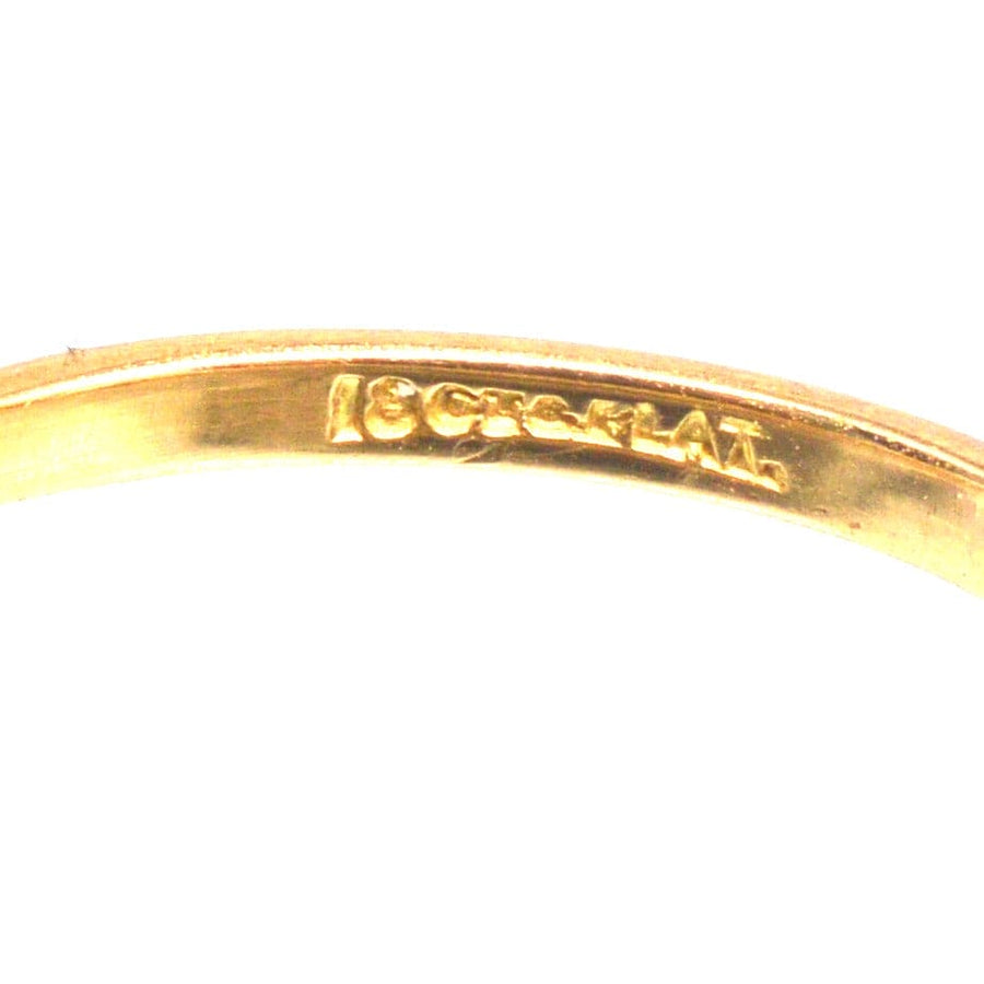 Close-up of 18ct gold and platinum hallmark inside Art Deco ring, showcasing craftsmanship and quality.