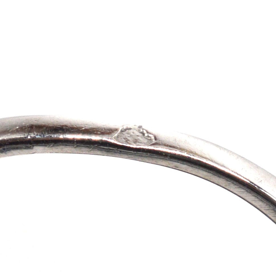 Close-up of the interior of a platinum ring showing a hallmark and detailed craftsmanship.