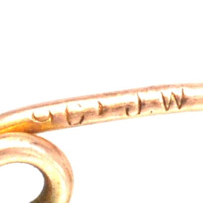 Close-up of hallmark engraving on Edwardian 9ct gold Stafford Knot bar brooch, showcasing its authenticity and craftsmanship.