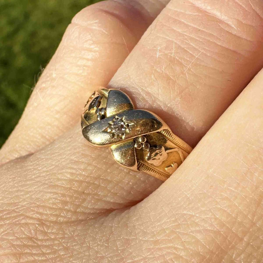 Victorian 18ct gold and diamond kiss ring with floral details and 'X' design, symbolizing love and new beginnings.