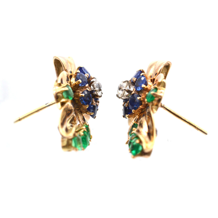 Retro 1940s 18ct gold Tutti Frutti earrings featuring emerald, diamond, and sapphire gemstones in vibrant design.