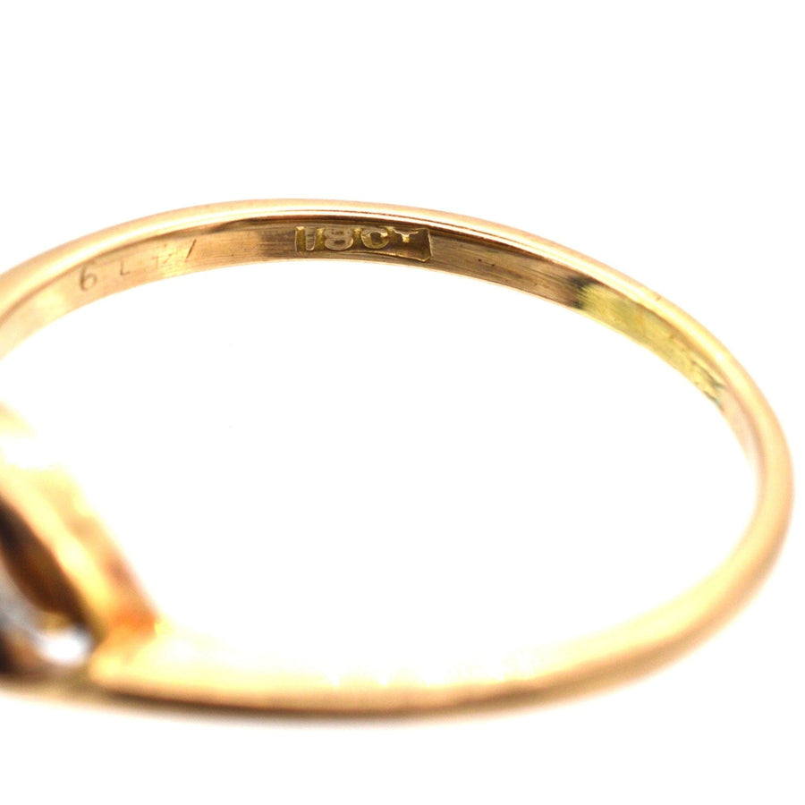 Close-up of the inner band of an Art Deco 18ct gold diamond twist ring, showing engraved hallmark.