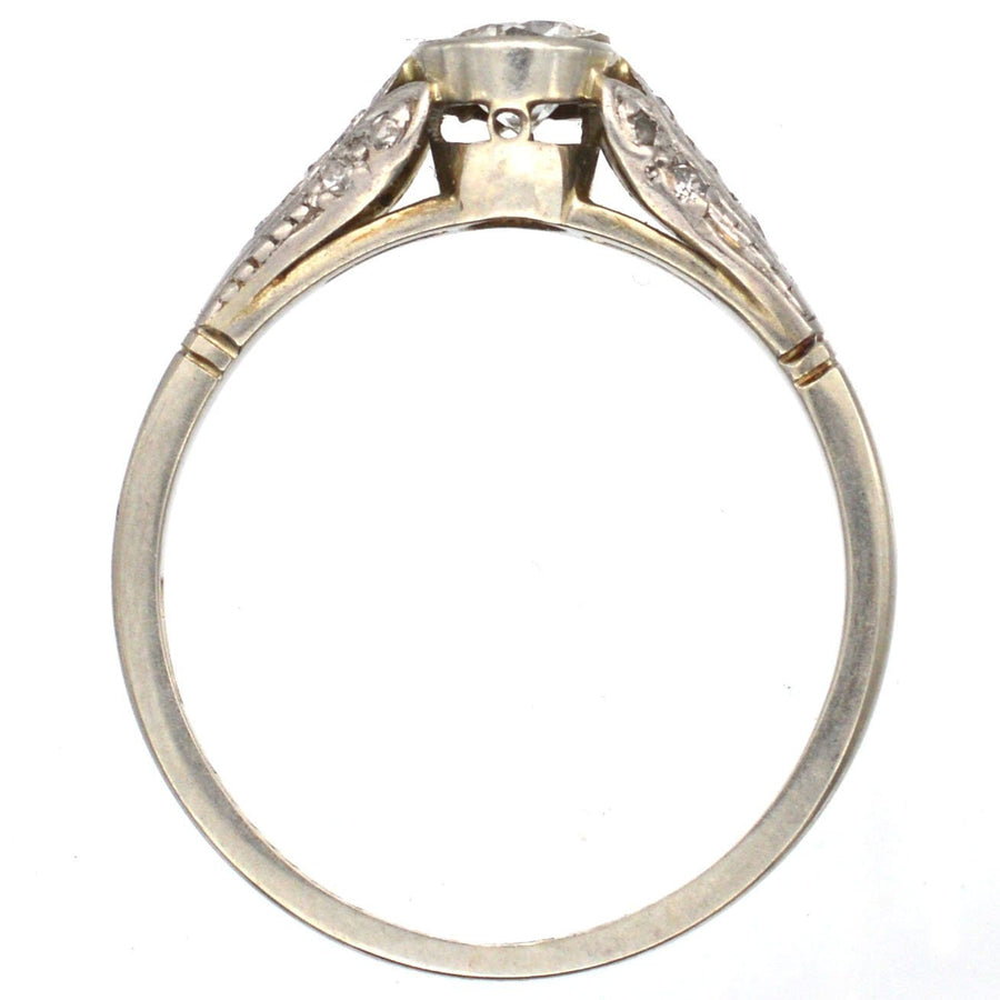 Art Deco 18ct gold and diamond solitaire ring with decorated shoulders, featuring a 0.40 carat center diamond.