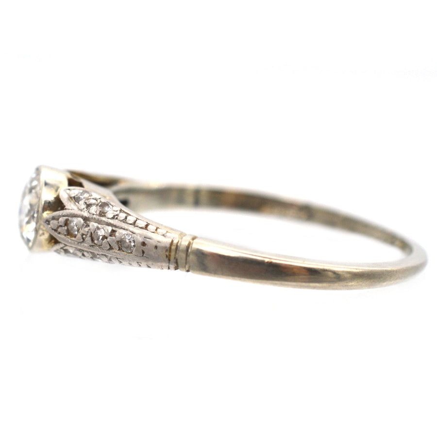 Art Deco 18ct gold diamond solitaire ring with detailed shoulders and exquisite craftsmanship.