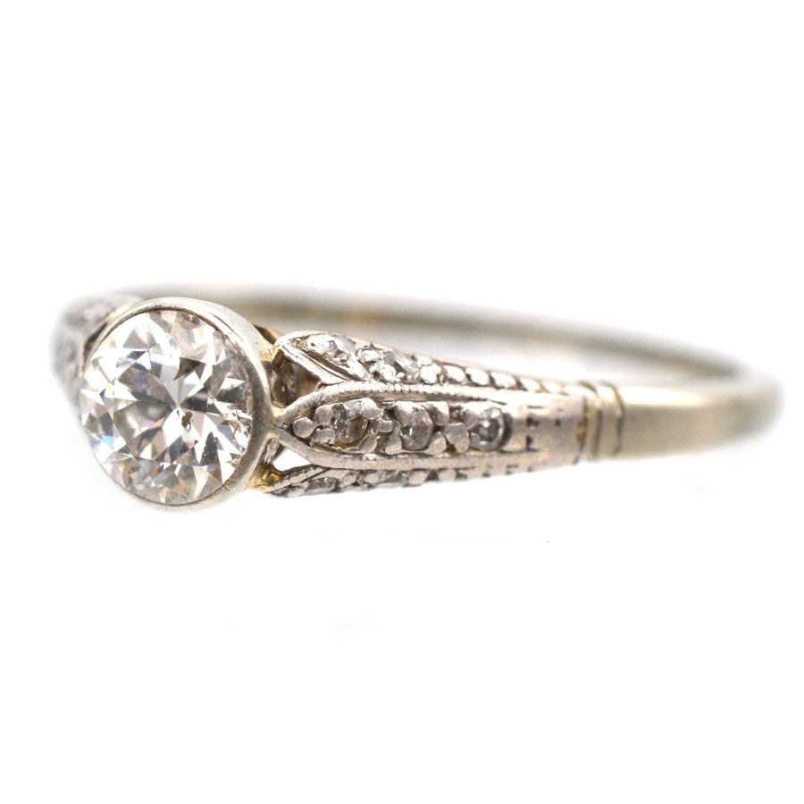 Art Deco 18ct gold diamond solitaire ring, featuring a central 0.40ct diamond and decorated shoulders.
