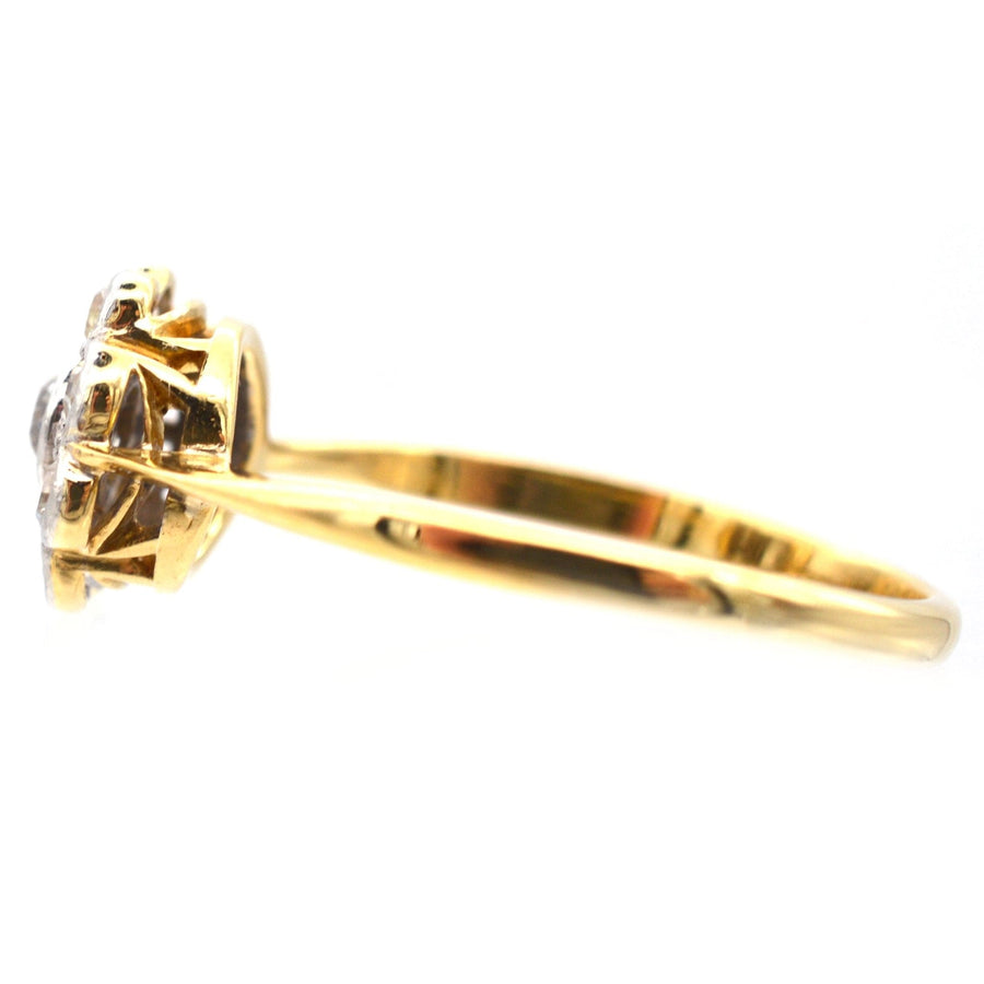 Art Deco 18ct gold and platinum diamond cluster ring showcasing exquisite millegrain setting detail.