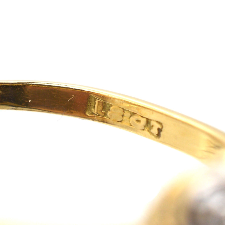 Close-up of 18ct gold hallmark inside Art Deco diamond cluster ring, showcasing quality craftsmanship.