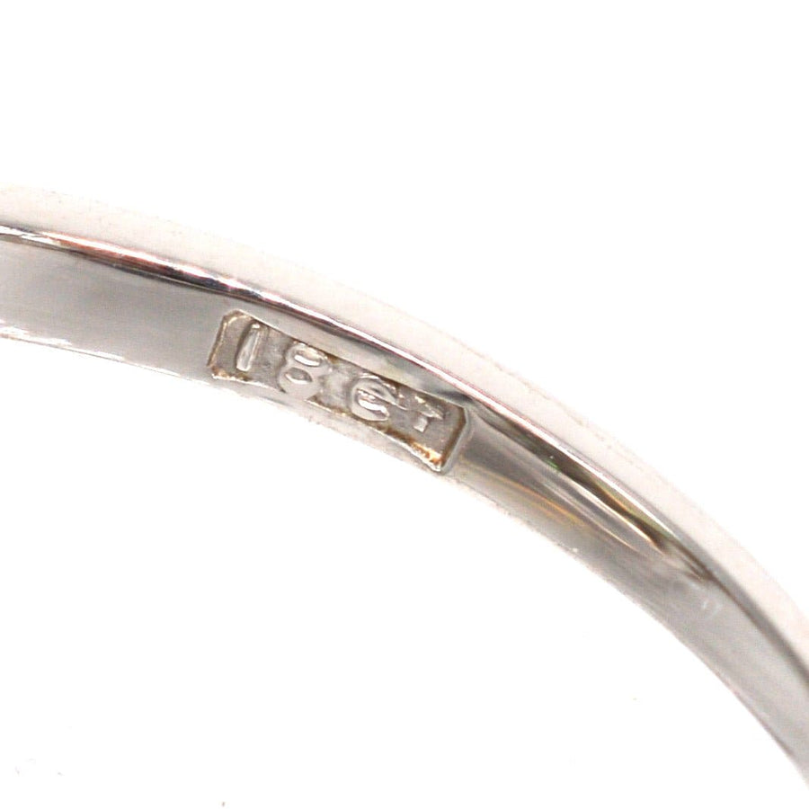 Close-up of ring band showing 18ct gold hallmark and smooth polished surface for authenticity and quality assurance.