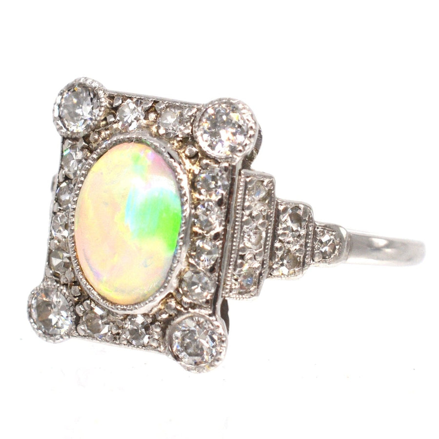 Art Deco 18ct gold and platinum opal and diamond ring with oval opal and 10 surrounding diamonds.