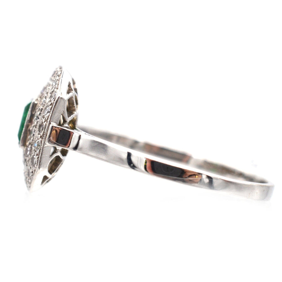 Art Deco 18ct white gold and platinum emerald diamond ring, side view showcasing the cluster design and millegrain setting.