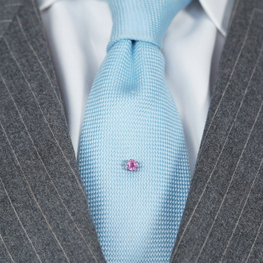 Art Deco 18ct gold tie pin featuring a 1 carat pink sapphire on a light blue silk tie.