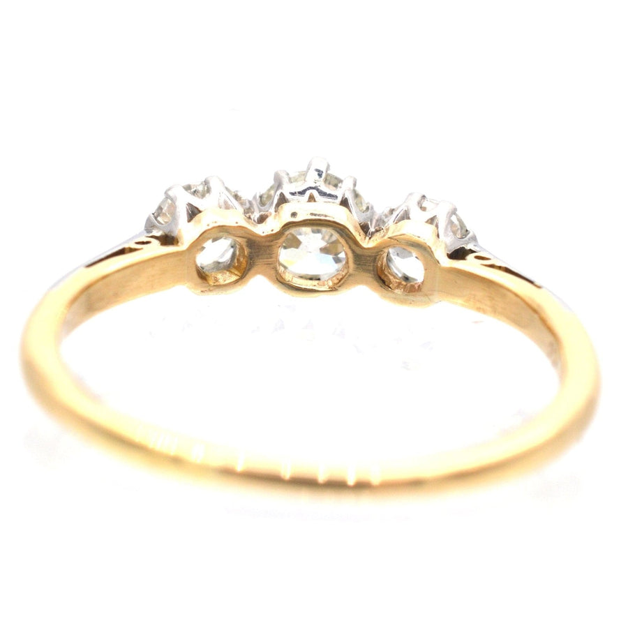 Art Deco platinum and 18ct gold three stone diamond ring, featuring clear diamonds, ideal for engagement.
