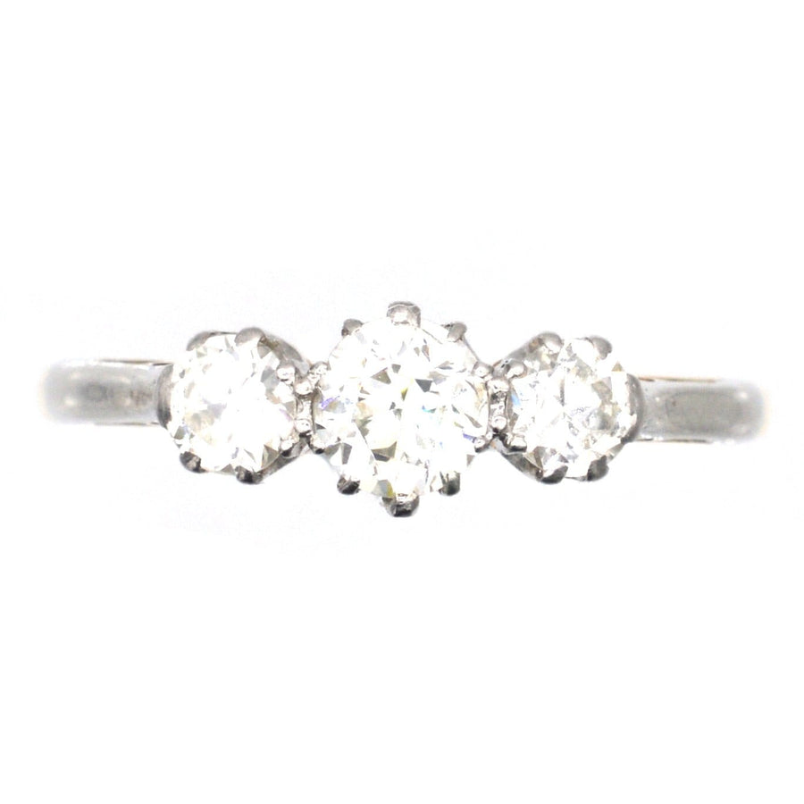 Art Deco platinum and 18ct gold diamond three stone ring, featuring clear, white diamonds, perfect for engagement.