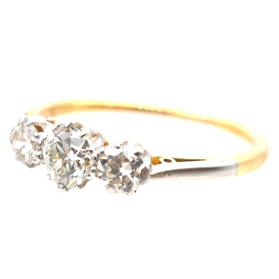 Art Deco platinum and 18ct gold three stone diamond ring, showcasing clear and sparkling diamonds, perfect for engagements.