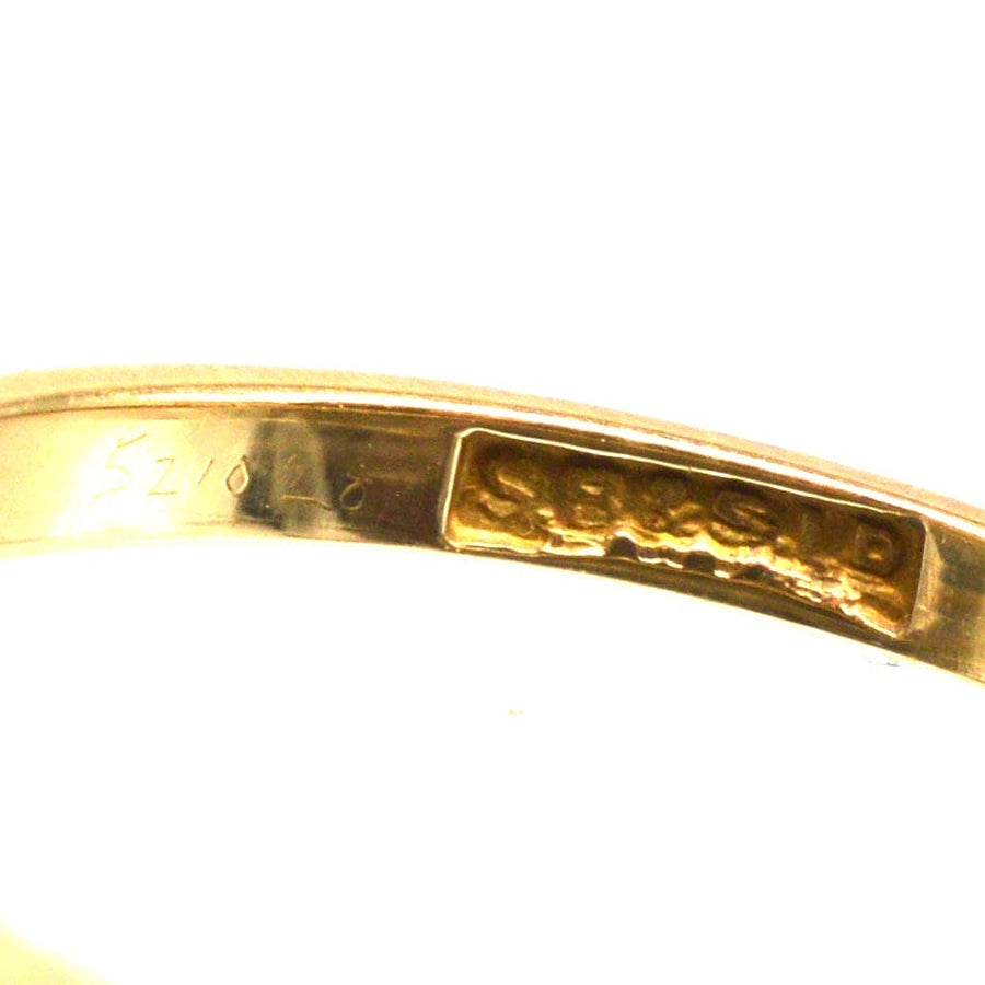 Close-up of an 18ct gold hallmark inside a ring band showcasing craftsmanship and quality.