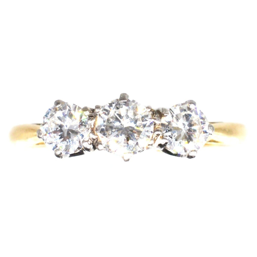 Art Deco platinum and 18ct gold three stone diamond ring, featuring bright round diamonds, perfect as an engagement ring.