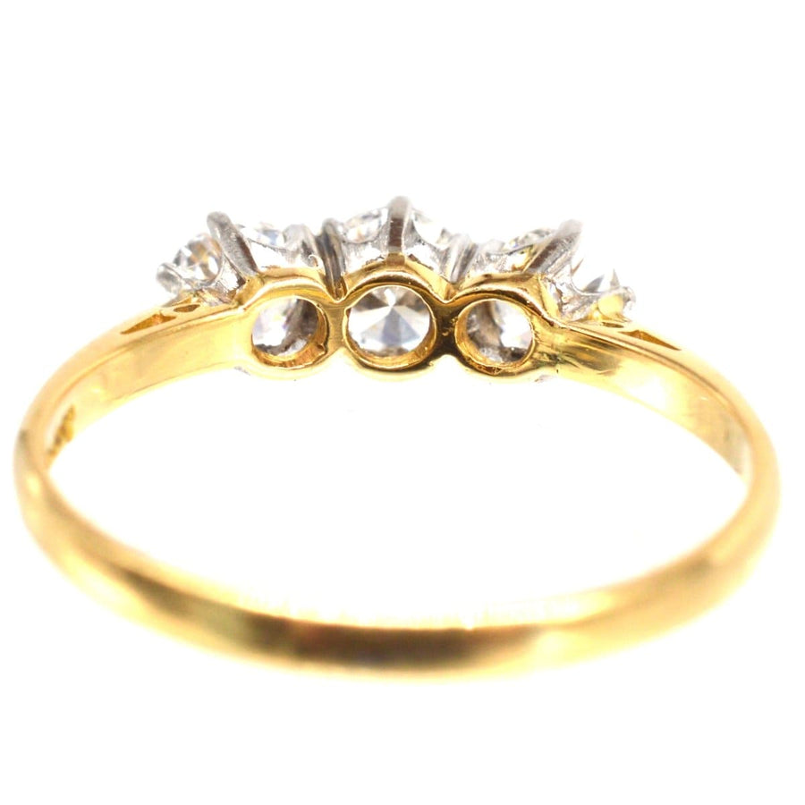 Art Deco platinum and 18ct gold three stone diamond ring showcasing large, bright diamonds in a timeless design.