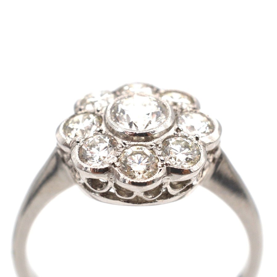 Art Deco platinum diamond cluster ring featuring over a carat of sparkling diamonds in a classic millegrain setting.