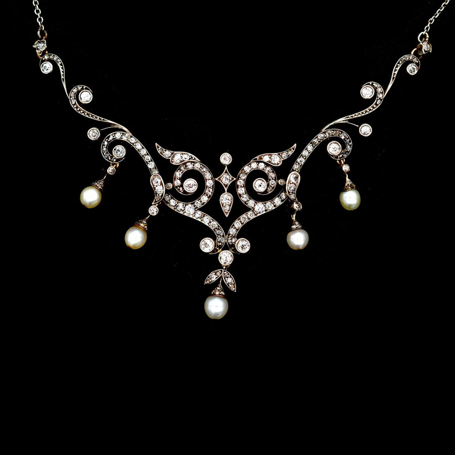 Edwardian diamond and natural pearl necklace, circa 1900, featuring intricate scroll designs and original case.