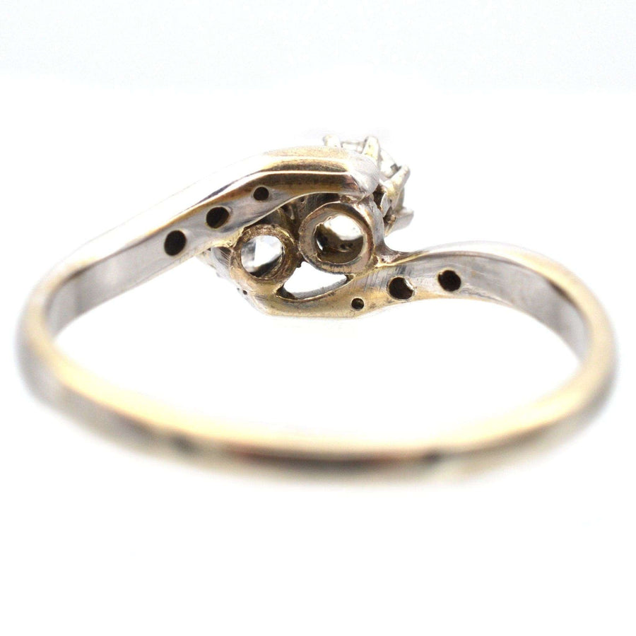 Elegant Edwardian 18ct white gold crossover ring showcasing two sparkling diamonds in a romantic 'Toi et Moi' design.