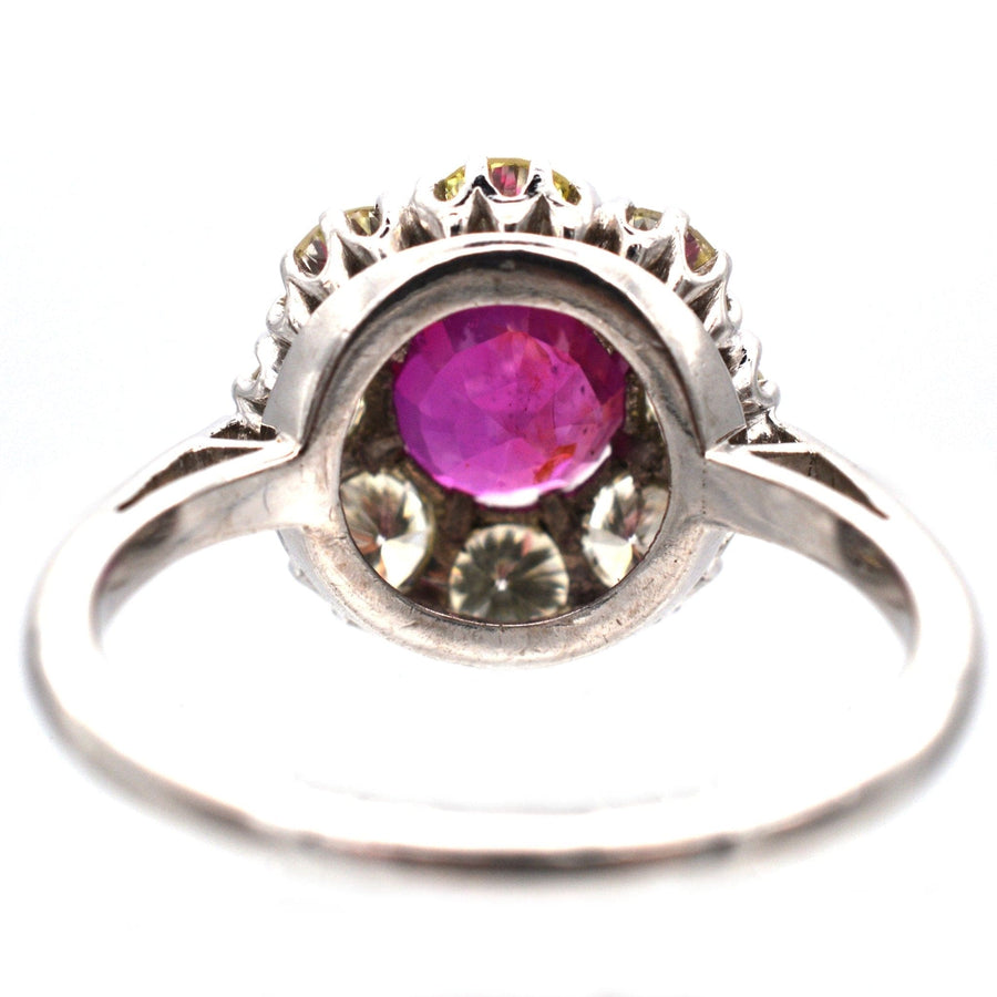 Mid 20th Century platinum ring featuring a 1.7 carat Burma ruby and diamond cluster design.