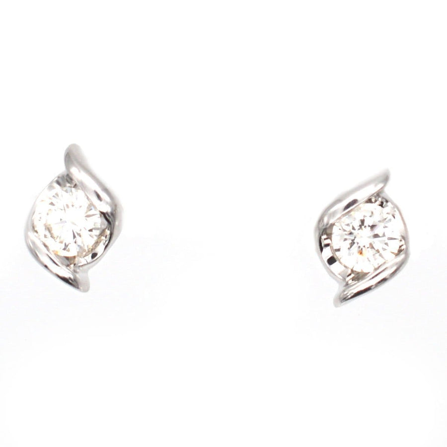 Modern 18ct white gold diamond stud earrings with twist detail, perfect for day or night wear.