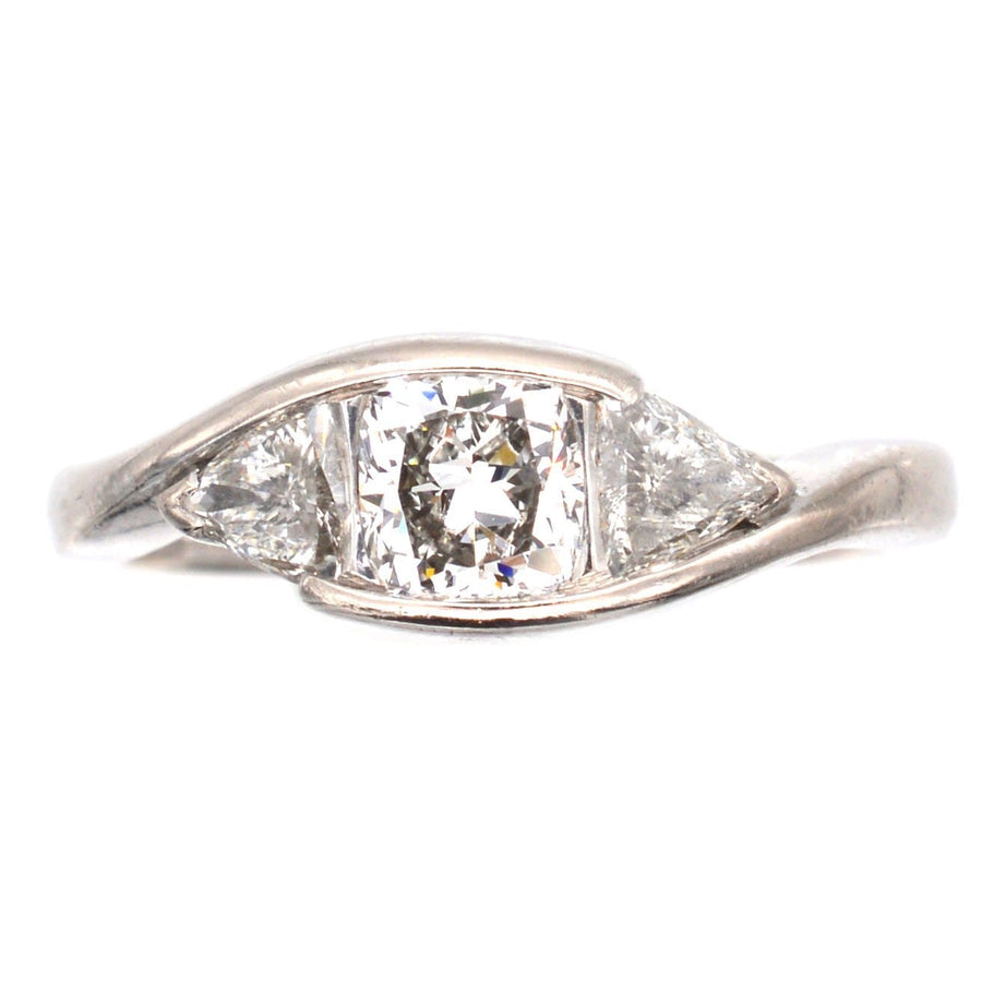 Modern 18ct white gold three stone diamond ring with GIA certified cushion cut diamond and trillion cut sides.