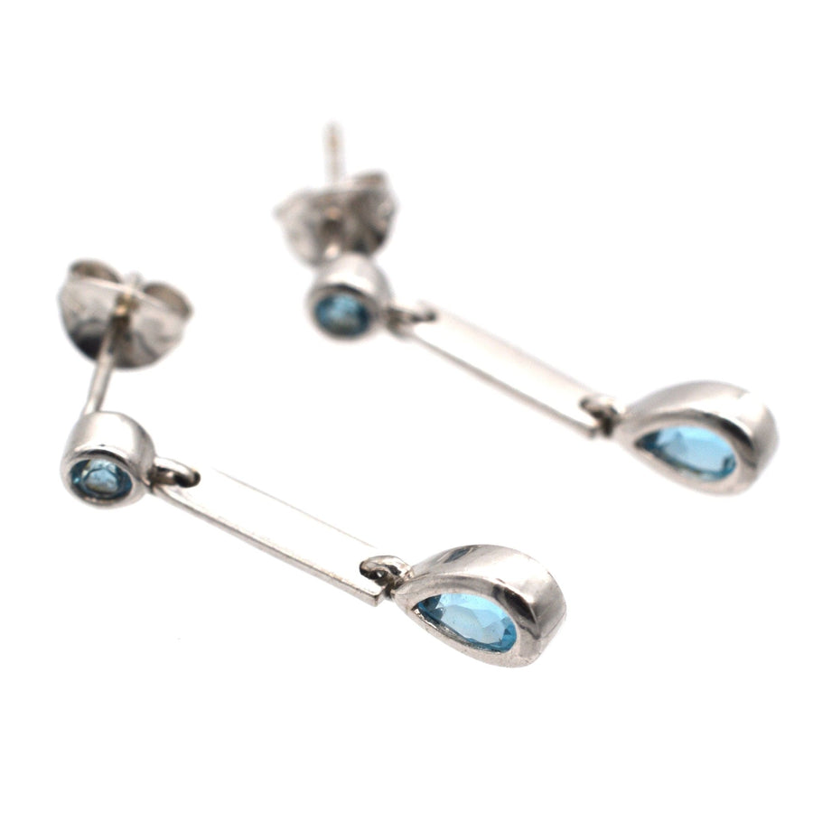 Modern 9ct white gold earrings featuring blue spinel pear drop design, perfect for elegant day-to-night wear.