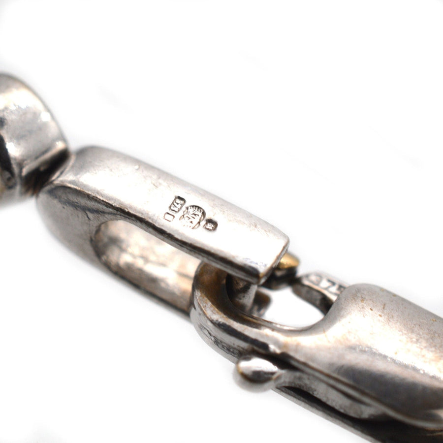 Close-up of a clasp on a 9ct white gold diamond bracelet, showcasing the quality hallmark and metal detailing.