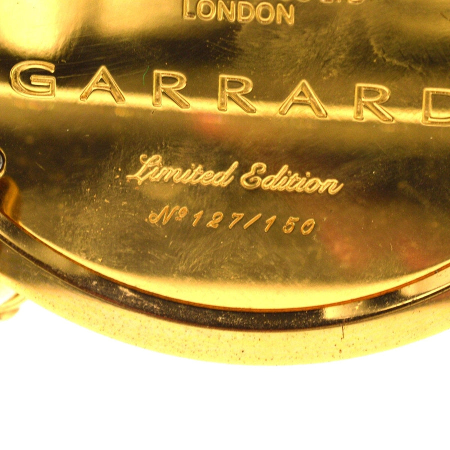 Close-up of the base of a vintage Garrard limited edition travel alarm clock, showing engraving No. 127/150.